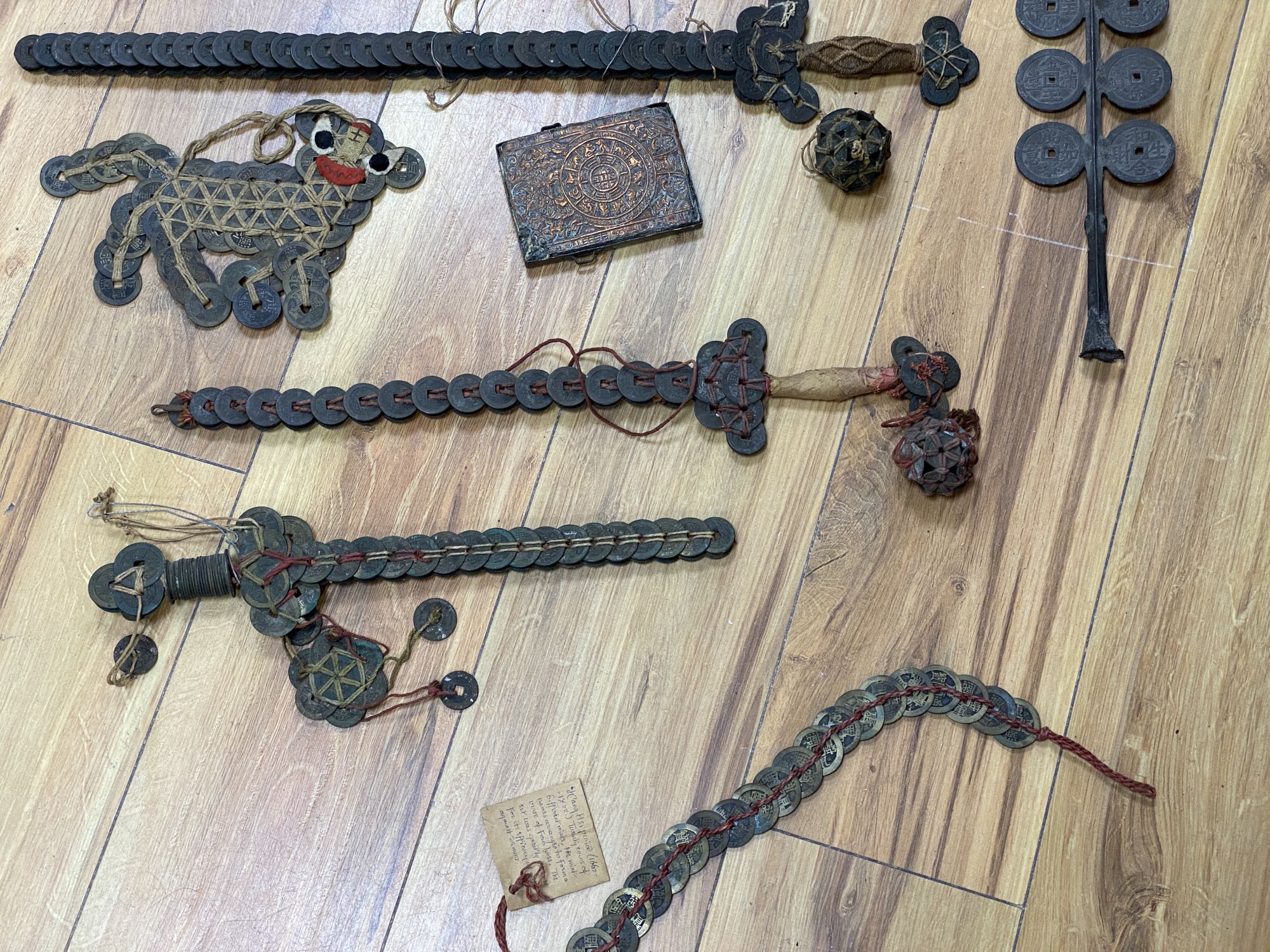 A group of Chinese coin swords and talismans,